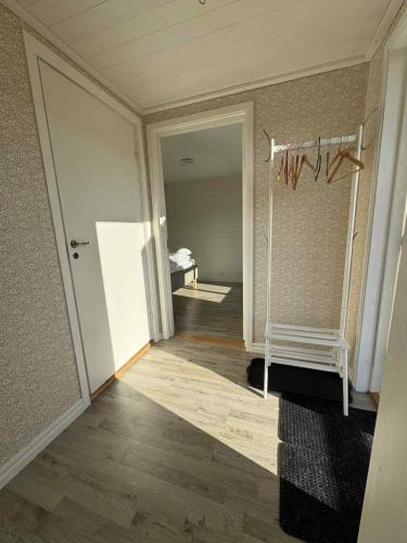 an empty room with a hallway with a door and a room with a table at Tiny House with ocean view in Näs
