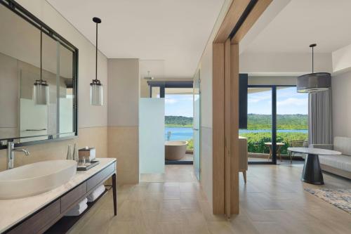 a bathroom with two sinks and a large mirror at Manado Marriott Resort & Spa in Manado