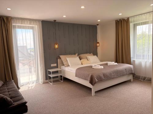 a bedroom with a bed and a large window at Manor 2 in Stará Lesná