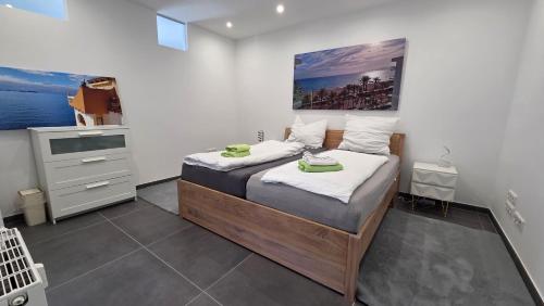 a bedroom with two beds and a sink in it at Auszeit am Eifeltor in Euskirchen in Euskirchen