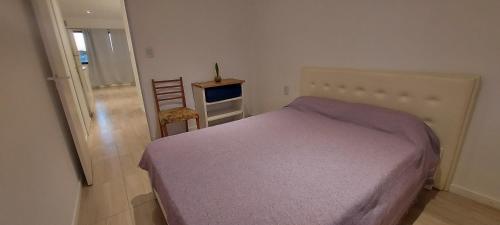 a bedroom with a bed and a table and a chair at Alquiler cintia in Gualeguaychú