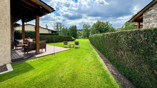 a garden with a table and chairs and a fence at La Maison du Fleuve in Ur