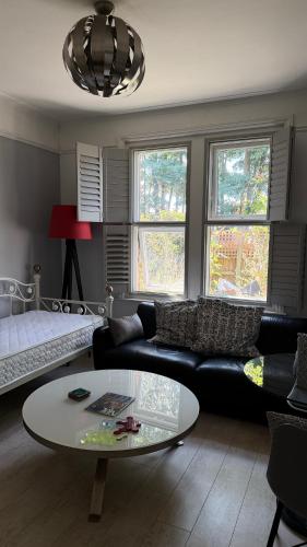 a living room with a couch and a table at Bournemouth. Private Self Contained space. in Bournemouth