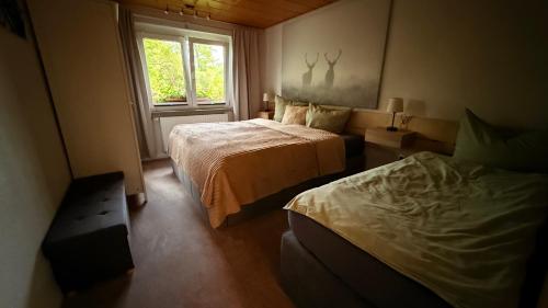 a bedroom with two beds and a window at Ferienhaus Elsterblick in Bad Elster