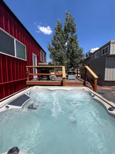 a hot tub in a yard next to a red building at Zion Basecamp Private Hot Tub Near Trails in Apple Valley