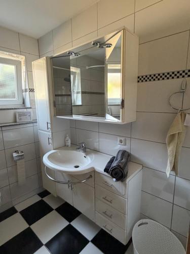 ein Badezimmer mit Waschbecken und Spiegel in der Unterkunft rottweilsuite in Villingendorf