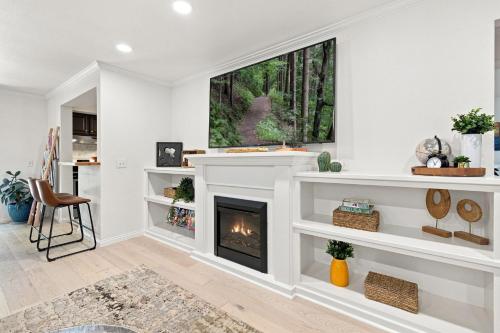 a living room with a fireplace and a window at Gravity Getaway in Bella Vista