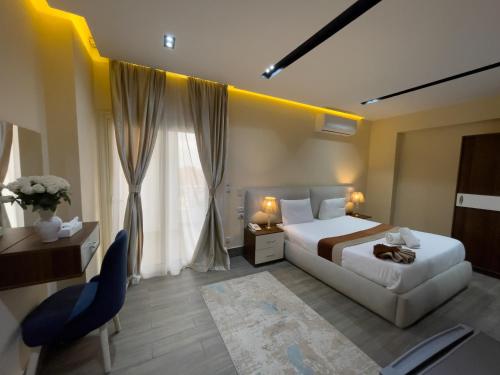 a hotel room with a bed and a desk and a chair at Pyramids Sunshine Hotel in Cairo