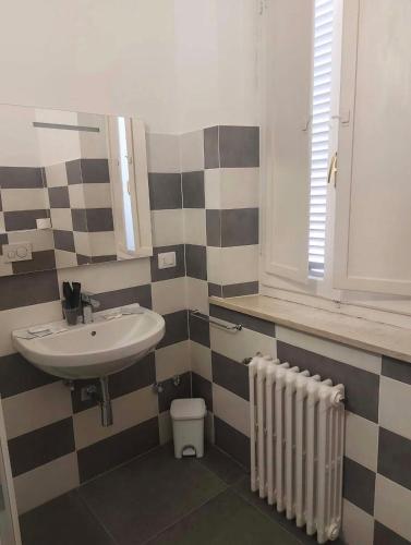 a bathroom with a sink and a radiator at Villa Santa Chiara in Loreto