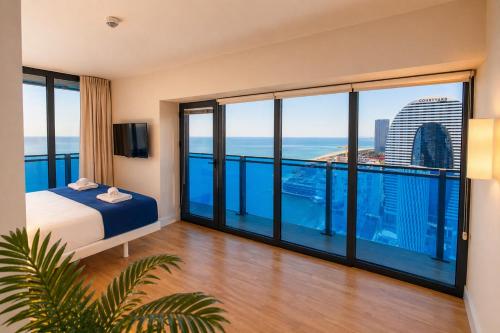 a hotel room with a view of the ocean at Orbi City Panorama Hotel & Sea View Balcony in Batumi