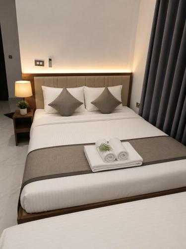 a hotel room with a bed with a scale on it at ANABEE HOLIDAY Inn in Jaffna
