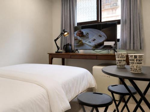 a bedroom with a bed and a table and a window at Stay brick in Seoul