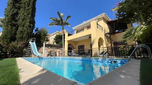 a swimming pool in front of a house at Luxury 3Bedroom Villa with Pool, Garden & Sunset in Tala