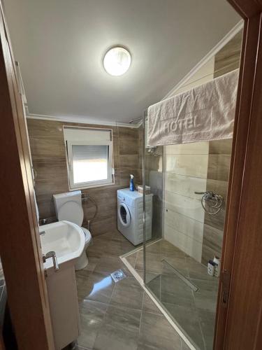 a bathroom with a toilet and a sink and a shower at Vila Denda Herceg Novi in Herceg-Novi