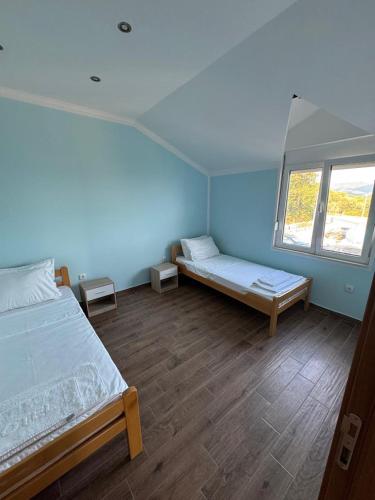 a bedroom with two beds and a window at Vila Denda Herceg Novi in Herceg-Novi