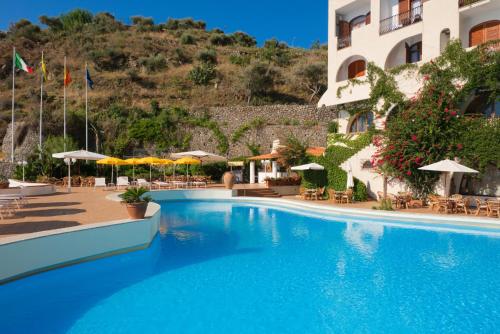 a large swimming pool in front of a hotel at Hotel Carasco in Lipari