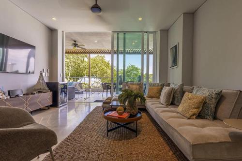 a living room with a couch and a table at 3 Bedroom apt with jacuzzi in Baru in Cartagena de Indias