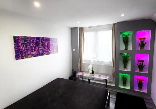 a dining room with a table and a window with flowers at Stay4U Veszprém in Veszprém