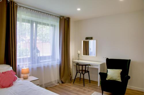 a bedroom with a bed and a desk and a window at Manor in Stará Lesná