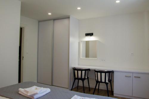 a room with two chairs and a table and a mirror at Manor in Stará Lesná