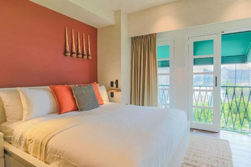 a bedroom with a white bed and a balcony at Casa México in Mexico City