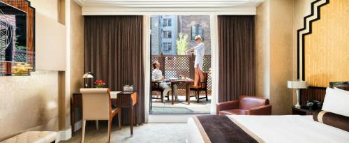 a hotel room with a bed and a balcony at Walker Hotel Greenwich Village in New York