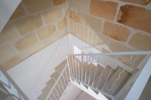 a spiral staircase with a brick wall at Hotel Cas Ferrer Monjo in Ciutadella
