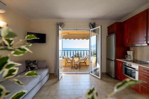 a living room with a couch and a kitchen with a table at Corfu Glyfada Beach Apartment 40 in Glyfada