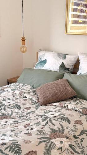 a bed with a comforter on it in a bedroom at Naša Priča Silver Lake in Veliko Gradište
