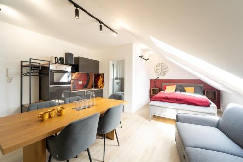 a room with a dining table and a bed at Glückszeit Apartments Gießen in Gießen