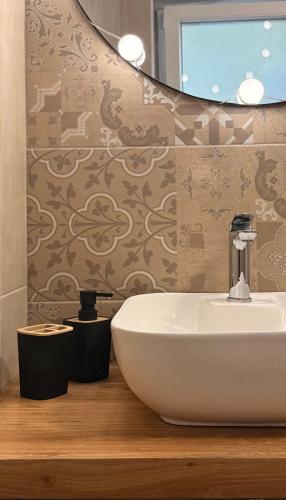 a bathroom with a white sink and a mirror at Naša Priča Silver Lake in Veliko Gradište
