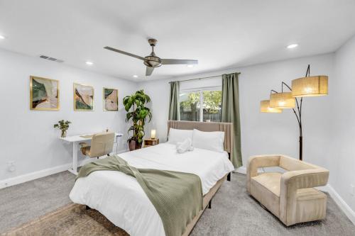a bedroom with a bed and a chair and a desk at Hot Tub Fire Pit 10 Min From DFW Airport in Irving