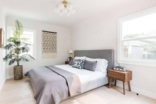 a white bedroom with a large bed and a window at Atlas Horizon Lodge in Imlil
