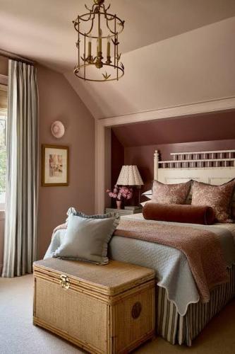 a bedroom with a large bed and a chandelier at Atlas Horizon Lodge in Imlil