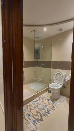 a bathroom with a glass shower and a toilet at nouhaila Lag in Rabat