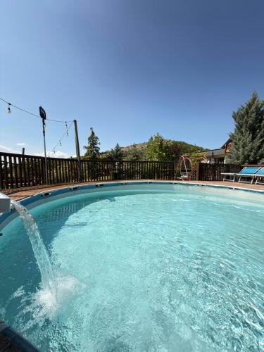 a swimming pool with a water fountain in it at Paradise Villa in Gracanica