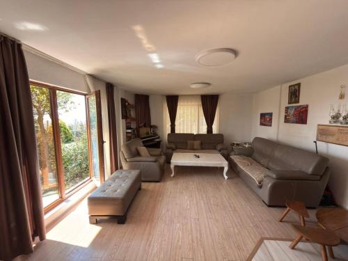 a living room with a couch and a table at Paradise Villa in Gracanica