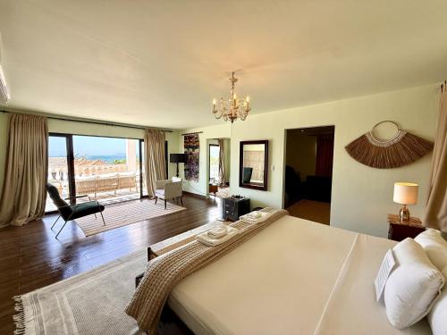 a bedroom with a large bed with a view of the ocean at Hotel Villa Toti in Santa Verónica
