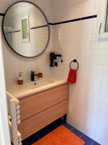 a bathroom with a sink and a mirror at Orée de Villevert in Senlis