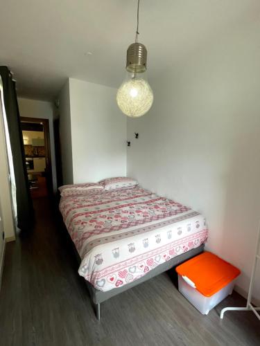 a bedroom with a bed and a light fixture at Bilocale fronte lago in Lovere