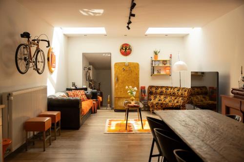 a living room with a couch and a table at Unique renovated chapel in Temse