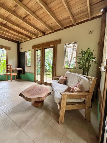a living room with a couch and a coffee table at El Cerrito in Puerto Jiménez