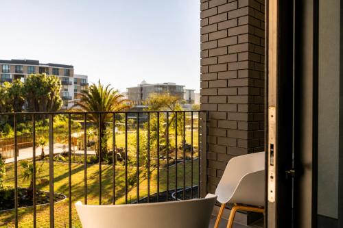 a balcony with a view of a park at On Park 516 At Century City in Cape Town