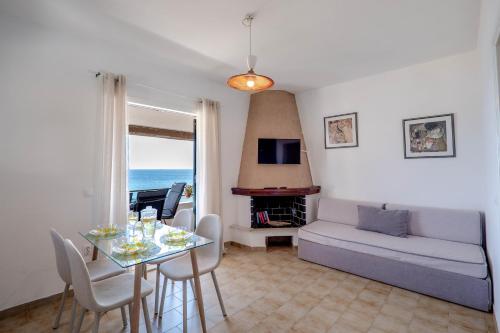 a living room with a table and a couch at Corfu Glyfada Beach Apartments 67 in Glyfada