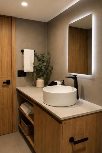 a bathroom with a white sink and a mirror at Sweven Hotel Boutique in Guadalajara