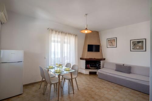a kitchen and living room with a table and chairs at Corfu Glyfada Beach Apartments 67 in Glyfada