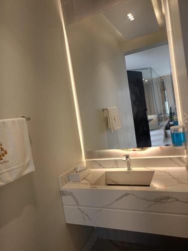 a bathroom with a sink and a mirror at استراحات وفلل رفايا in Abha