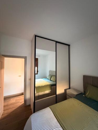 a bedroom with a bed and a mirror at Iva Apartment in Kumbor