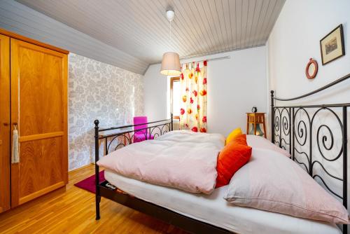 a bedroom with a bed with a black frame at Café Marie - Bed & Breakfast in Eggersdorf bei Graz
