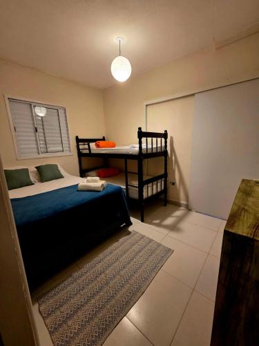 a bedroom with a bed and a table in it at Pousada Casa Meraki in São Sebastião